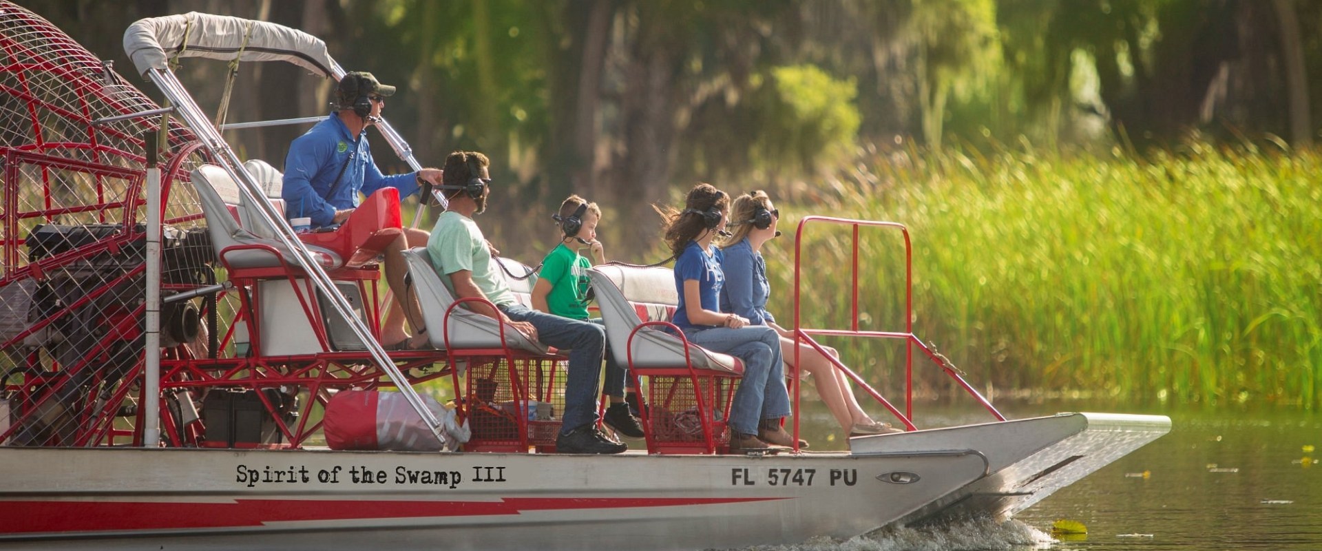 a group of people riding on the back of a boat