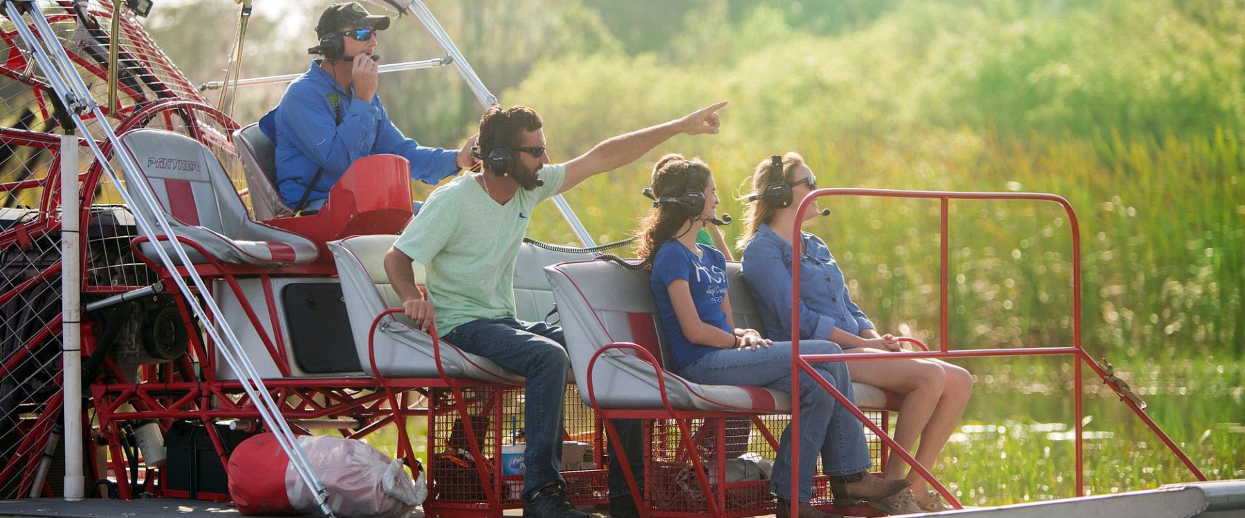 a group of people riding on the back of a boat