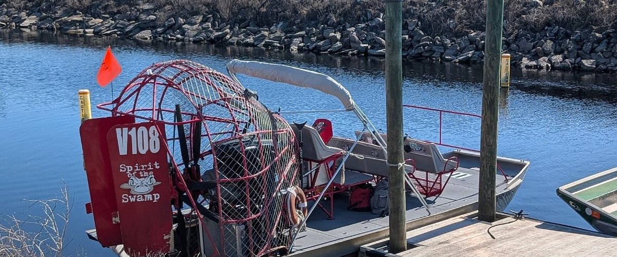 a boat is docked next to a body of water